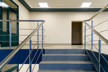 Stairwell in a modern building. An empty spacious hall with a flight of stairs in the business center. Emergency evacuation exit from the building in case of an earthquake or fire.