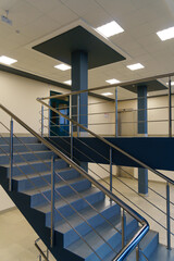 Fototapeta premium Stairwell in a modern building. Staircases as an emergency evacuation exit from the building in case of fire or emergency. Clean stairs and railings in the business center.
