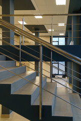 Stairwell in a modern building. Staircases as an emergency evacuation exit from the building in case of fire or emergency. Clean stairs and railings in the business center.