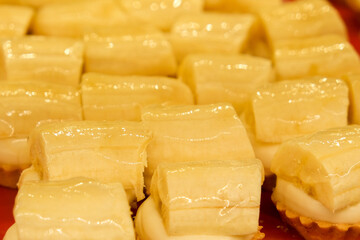 Small mini bite-size delicious sweet pastry creamy snack with banana fruit inside pastry