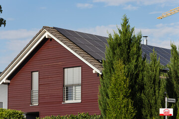 prefabricated building front of wood construction with solar panels on rooftop