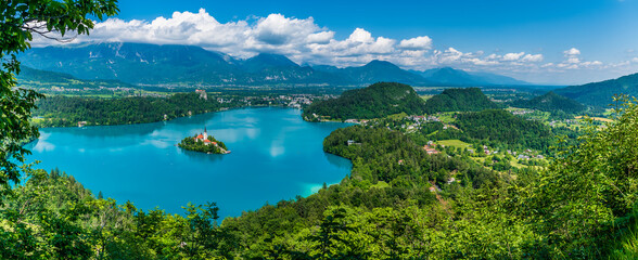Fototapeta na wymiar A panorama view from the Mala Osojnica viewpoint over Lake Bled and the surrounding countryside in Slovenia in summertime