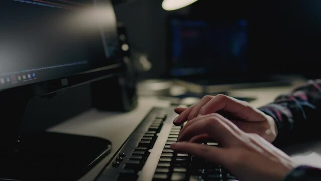 Programming and writing code, A girl is sitting at a table working on a laptop PC, The computer keyboard is a girl's hands writing a code by pressing buttons, Remote work at home remote work
