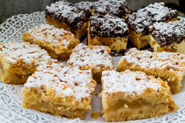 Delicious chocolate and sugar cakes on doily