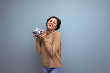 isolated background, cute young brunette hispanic woman with hairstyle received a gift for holiday birthday