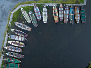 drone shot of small fishing and rowing boats on lough sheelin harbour, ireland