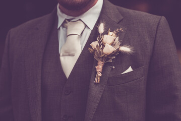 A grooms white rose buttonhole