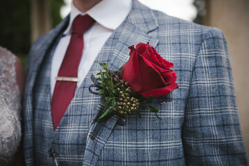 A grooms red rose buttonhole