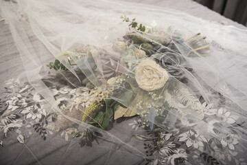 wedding bouquet covered by the veil