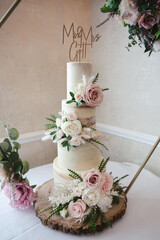 A traditional white wedding cake with floral decoration
