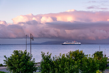 Fototapeta na wymiar Cruise ship at Galway port on early morning with a beautiful vivid sunrise