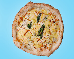 craft pizza with pear and mozzarella on a blue background, studio shooting