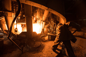 Fototapeta na wymiar Steelworker at work near the arc furnace
