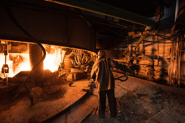 Steelworker at work near the arc furnace - 631627480