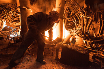 Steelworker at work near the arc furnace - 631628272