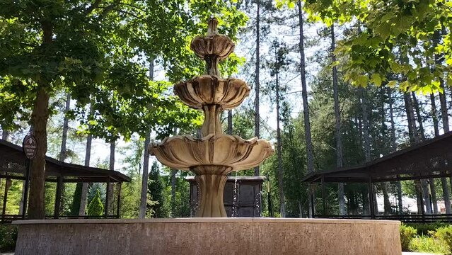 A beautiful stone fountain in the walking area to create an atmosphere of freshness and some antique inspiration when passers-by visit these places. Element of decor of architectural buildings.