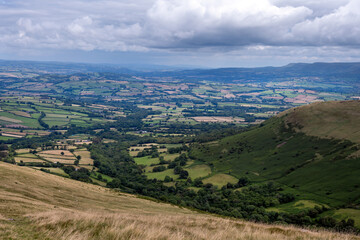 View from Bryn Teg ridge on a cloudy summer afternoon in the Brecon Beacon or Bannau Brycheiniog national park, Powys, Wales
