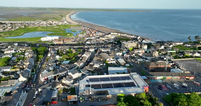 An aerial view of the amusement park against the backdrop of Tramore, Ireland 4k