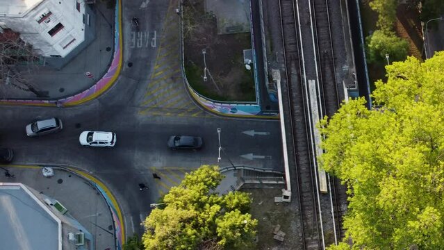 Cars crossing the intersection, people crossing the road in the wrong place, a cyclist passes in front of the car, traffic in Buenos Aires, drone footage