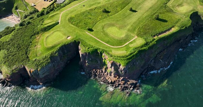 Incredible golf course on a rocky bluff near the ocean 4k