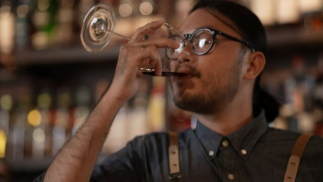 Night club concept of 4k Resolution. Bartender smiling confidently in a liquor store. A group of specialized clubs that sell alcoholic beverages.