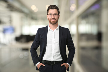 Handsome confident man with eyeglasses in office