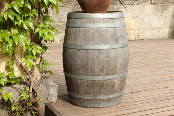 Fototapeta premium Traditional wooden barrel on street outdoors. Wine making