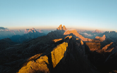 Aerial view over Tre cime region in the Sexten Dolomites, Northern Italy. Taken during beautiful, colorful sunrise. - obrazy, fototapety, plakaty