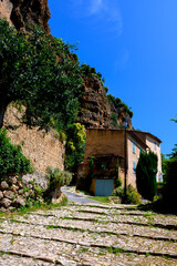 Travel destination, small ancient village Cotignac in Var, Provence, surrounded by vineyards and cliffs with troglodytes houses.