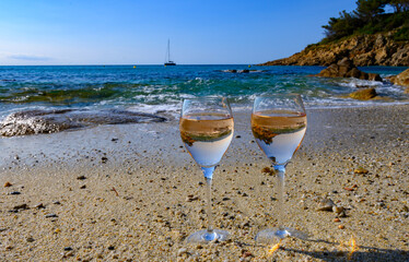 Summer time in Provence, two glasses of cold rose wine on Pampelonne sandy beach near Saint-Tropez in sunny day, Var, France
