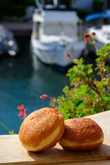 Fried in oil french stuffed with apples or chocolate beignets donuts pastry, sweet dessert served outdoor