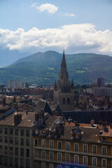 Obraz premium View from central part of Grenoble city to Bastille fortres witn mountains around, old cable car, Isere, France