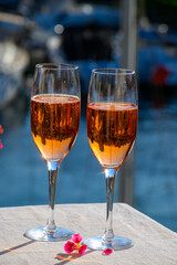 Summer party, drinking of French brut rose champagne sparkling wine in glasses in yacht harbour of Port Grimaud near Saint-Tropez, French Riviera vacation, France
