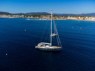 Aerial view on blue water of Gulf of Saint-Tropez, sail boats, houses of Port Grimaud, Port...