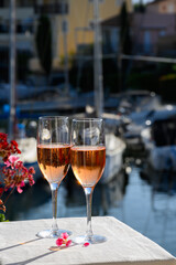 Summer party, drinking of French brut rose champagne sparkling wine in glasses in yacht harbour of Port Grimaud near Saint-Tropez, French Riviera vacation, France