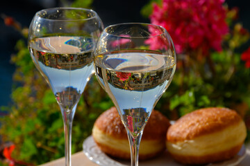 Drinking of French brut champagne sparkling wine with sweet apple Beignet, club party in yacht harbour of Port Grimaud near Saint-Tropez, French Riviera vacation, France