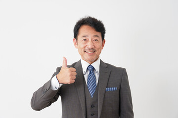 グッドポーズをするミドルエイジのビジネスマン　白背景