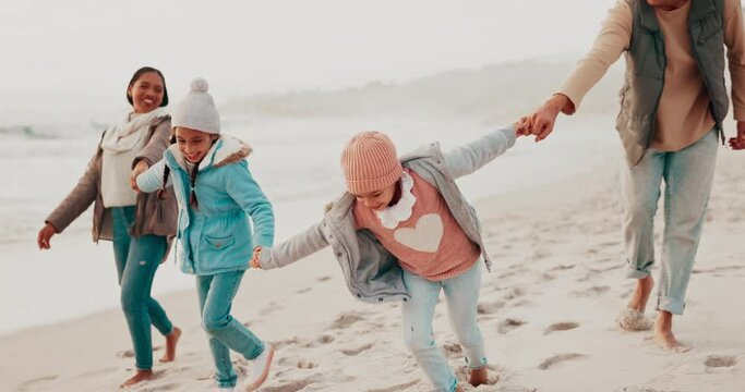 Bonding, walking and family holding hands on beach while on a tropical vacation or holiday. Fun, travel and children exploring on the sand by ocean with their parents on a winter seaside weekend trip
