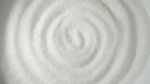 Macro video of Monosodium glutamate (MSG), a flavor enhancer used in food, reveals its tiny crystal structure. This white, odorless powder adds umami taste to dishes, captivating taste buds worldwide.