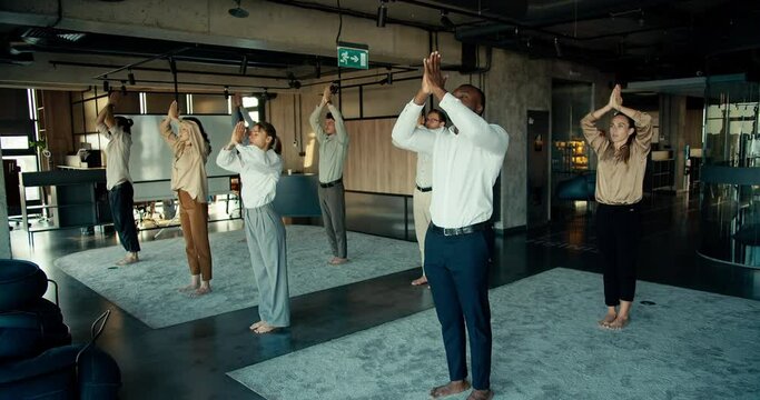 The practice of calmness and meditation for business people in the office. Break at work for group meditation in an international team