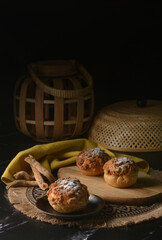 freshly handmade custard, chocolate, durian, matcha, cream puff w icing sugar cake pastry on dark luxury background with wood bamboo lantern decoration halal food dessert menu for cafe