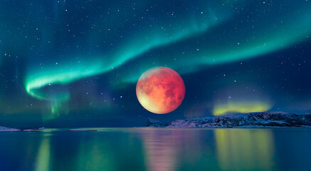 Northern lights - Aurora borealis in the sky with full red moon (lunar eclipse) on the foreground calm sea "Elements of this image furnished by NASA"