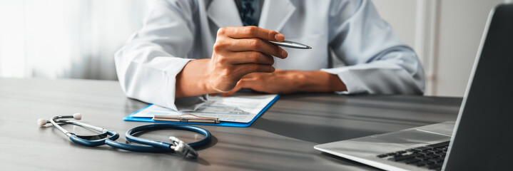 Doctor carefully review detailed medical report with laptop and diagnosing illness for effective...