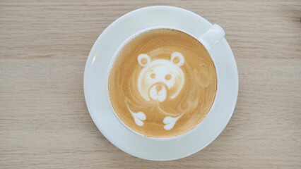 Hot art Latte Coffee in a cup on wooden table and Coffee shop