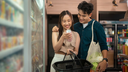 An Asian couple shopping in supermarket , concept of city life lifestyle