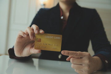 Woman hands holding and using cradit card for shopping online.