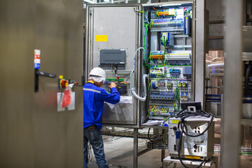 Electrician engineer tests electrical box control
