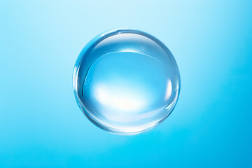 Perfect water drop. Liquid gel drop on blue background. Translucent glass ball of simple form. 
