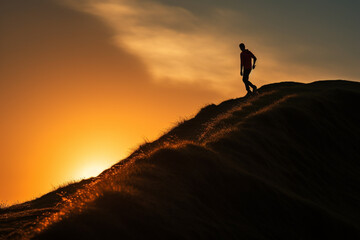 silhouette of a person climbing up the hill at sunset, aesthetic look