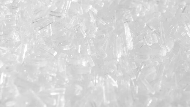 Macro video of Monosodium glutamate (MSG), a flavor enhancer used in food, reveals its tiny crystal structure. This white, odorless powder adds umami taste to dishes, captivating taste buds worldwide.